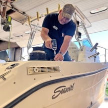 service technician working on a boat